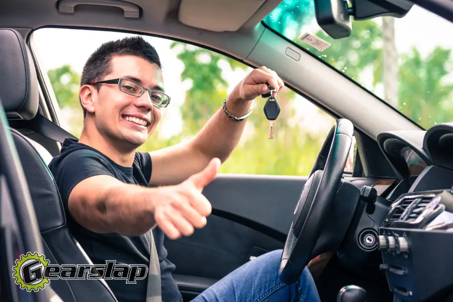 happy teenager test driving car