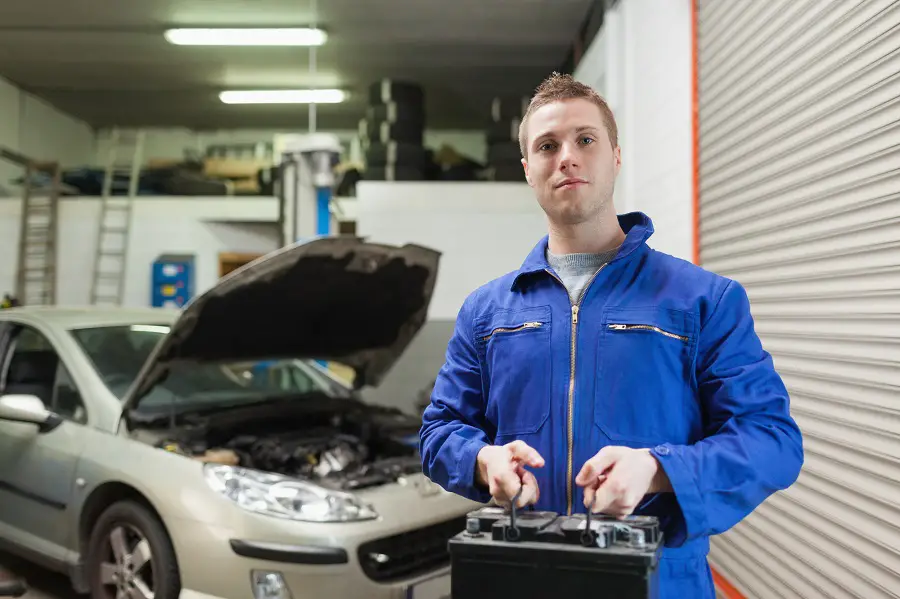 mechanic returning a car battery