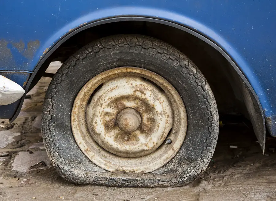 old car tire dry rot cracked and rotten