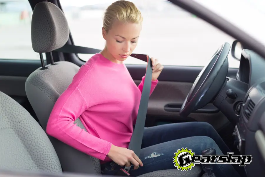 woman fastening seatbelt how to fix a stuck seat belt